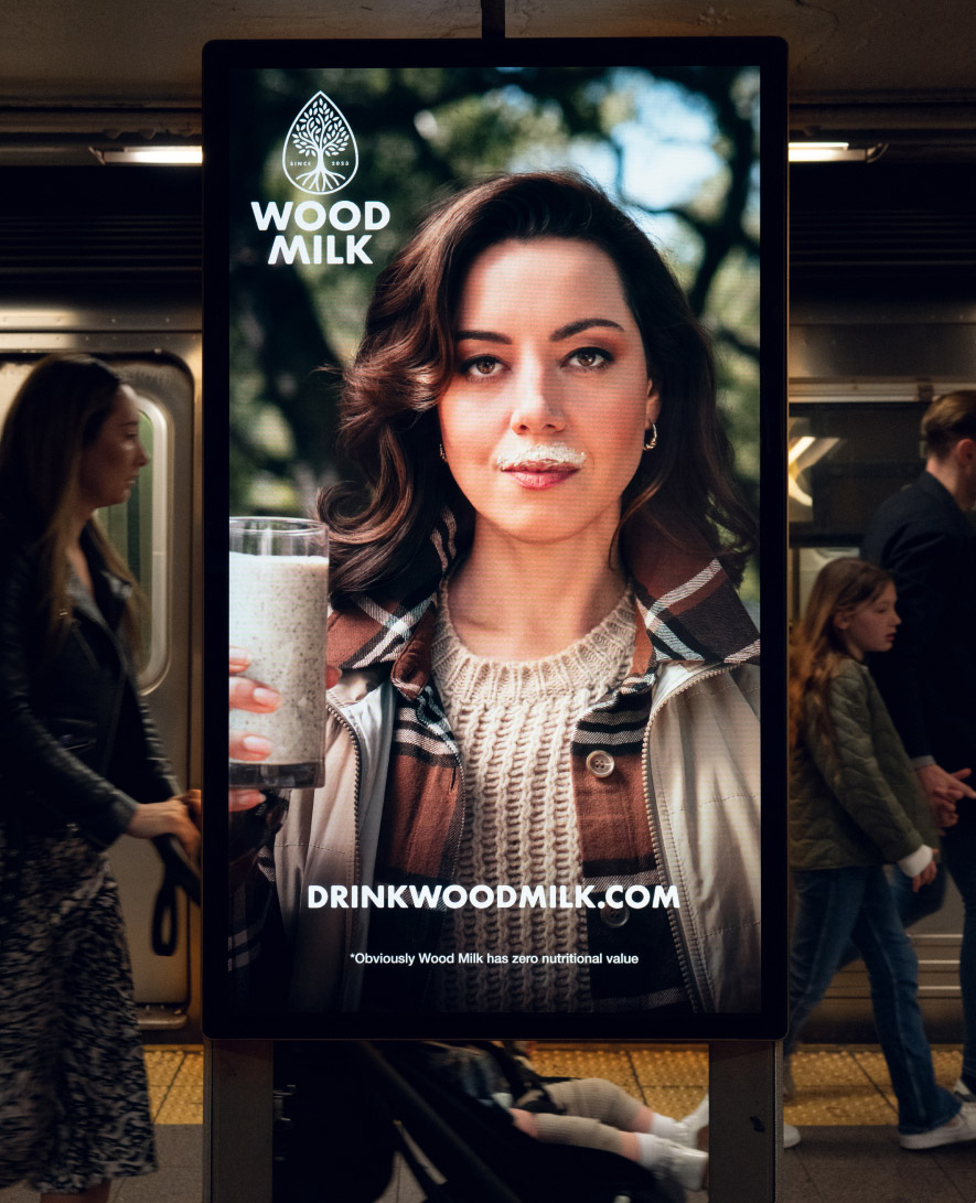 A digital Sign on a New York City subway platform depicting a woman runner and a QR code 